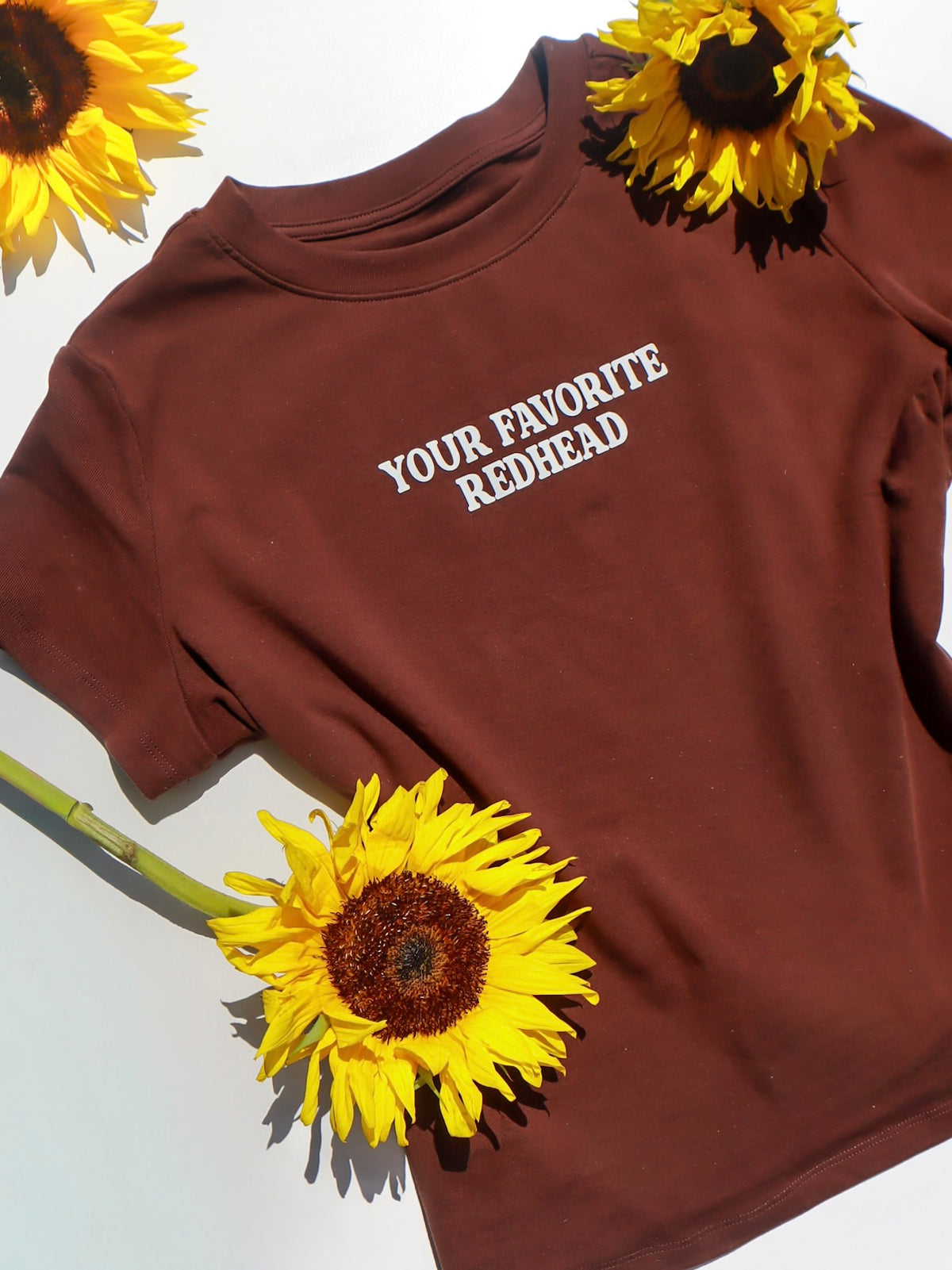 the 'your favorite redhead' baby tee